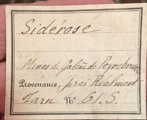 Ancienne étiquette Vésignié pour sidérite en périmorphose après calcite (mine de Peyrebrune).